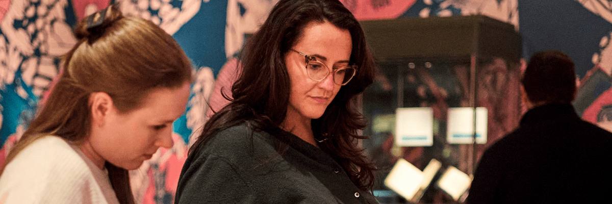 Two women looking at a case in a museum exhibit