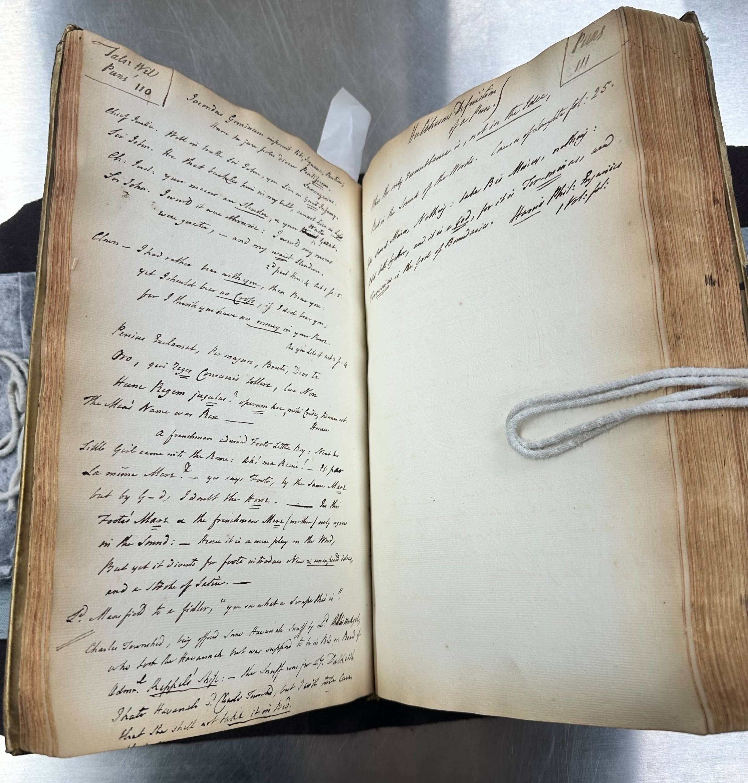 An opening of a large manuscript book showing a page page of text on the left and only a few lines on the right.