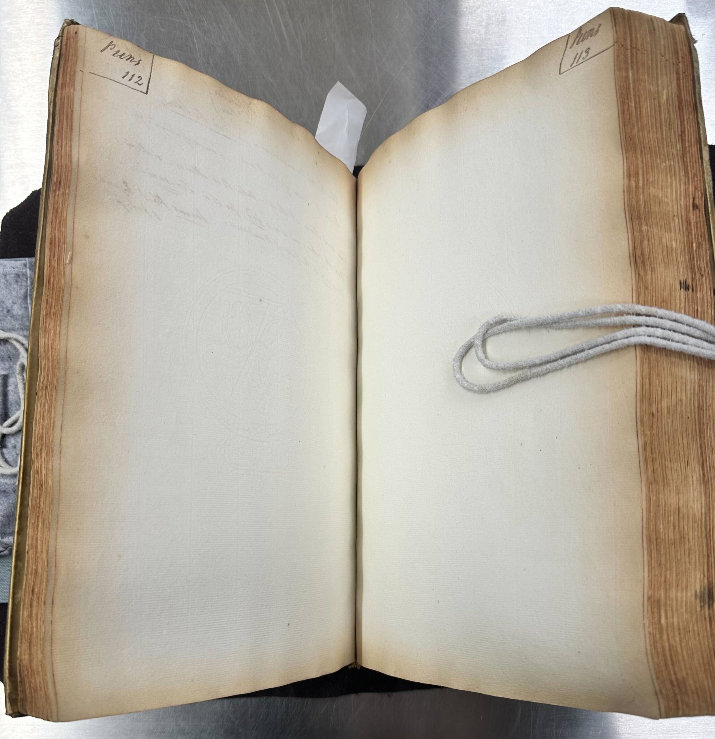 An opening of a large manuscript book. The opening is totally blank apart from the heading 