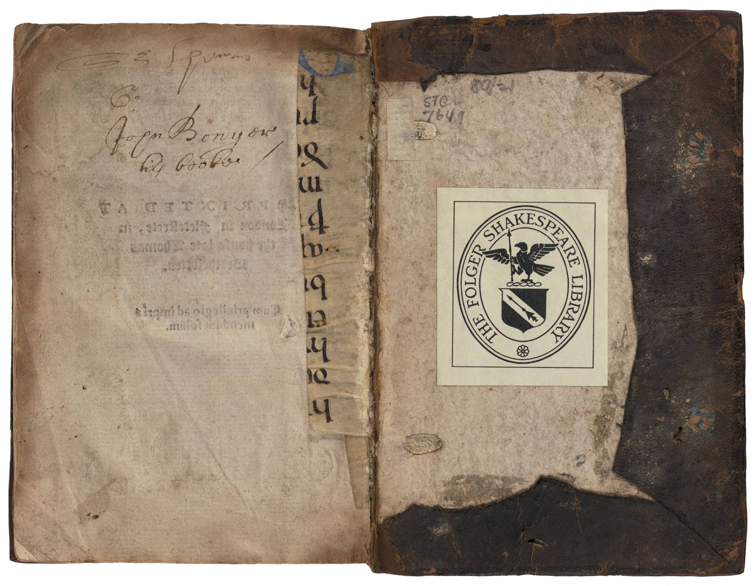 The final page and back board of a book showing a small sliver of manuscript text underneath plain paper with some additional manuscript in a later hand.