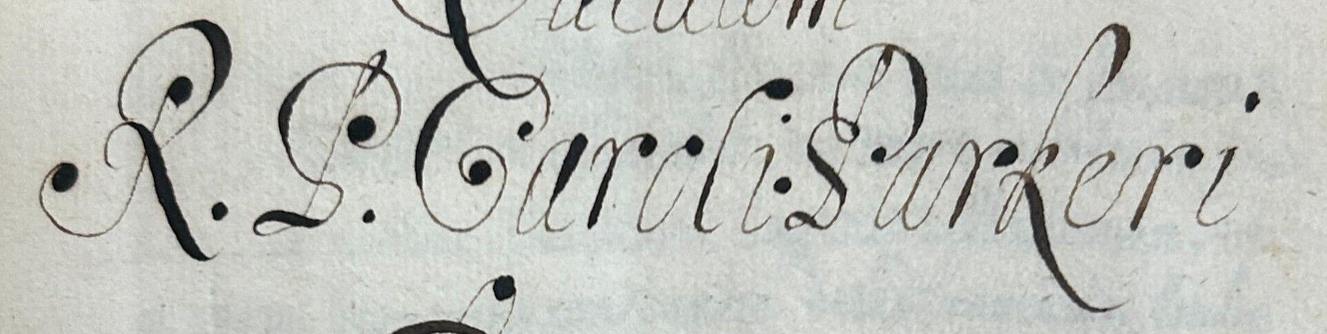 A close up of a Latin name in calligraphy