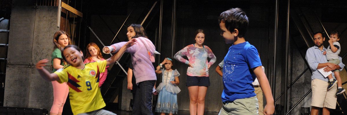 Group of children acting on a theater stage
