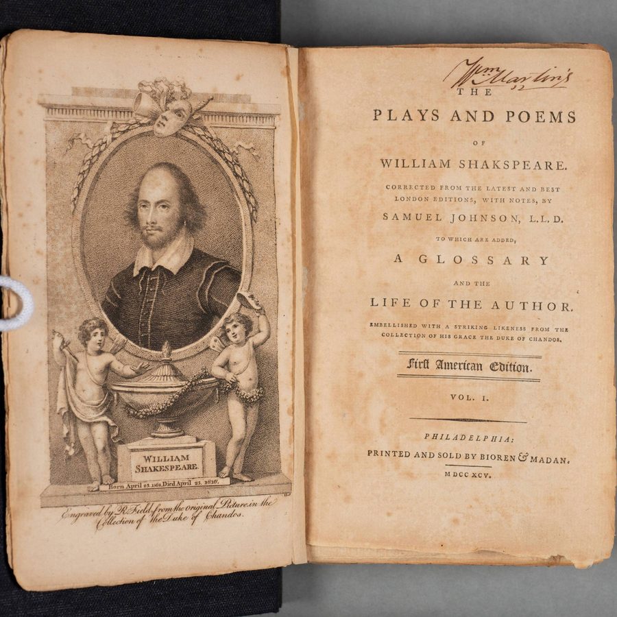 A set of eight upright books with cracked spines and handwritten titles facing outwards.