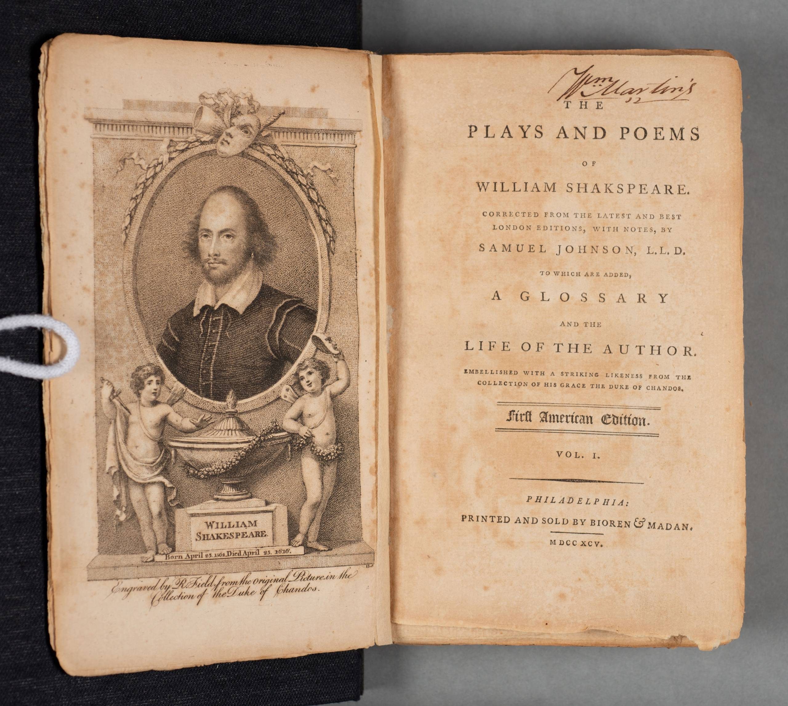 An open book showing a portrait of Shakespeare on one side and a printed title page on the other.