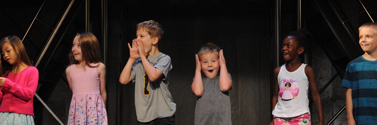 Six children standing on stage