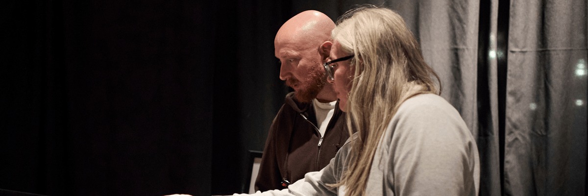 A man and a woman looking at an item in a museum case