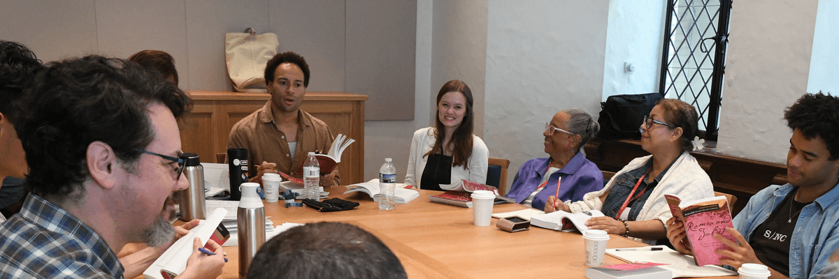 A group of adults sitting around a table talking
