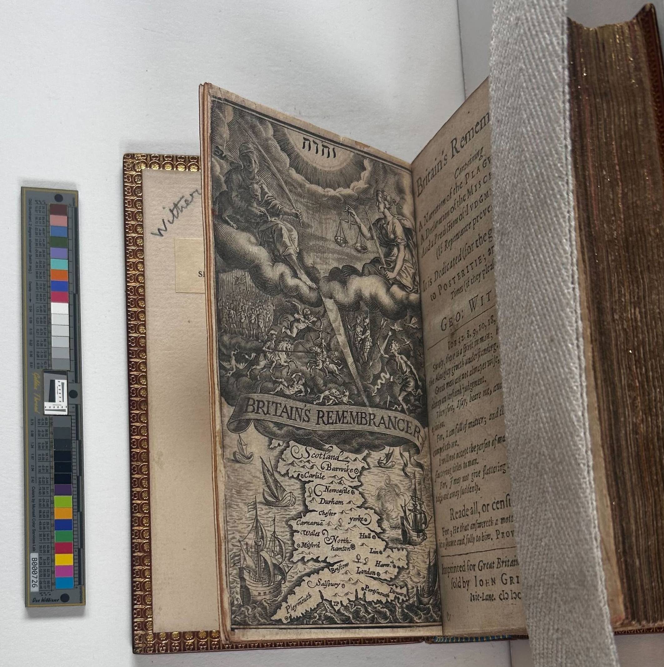 A book strapped open with the front page rising up from the board